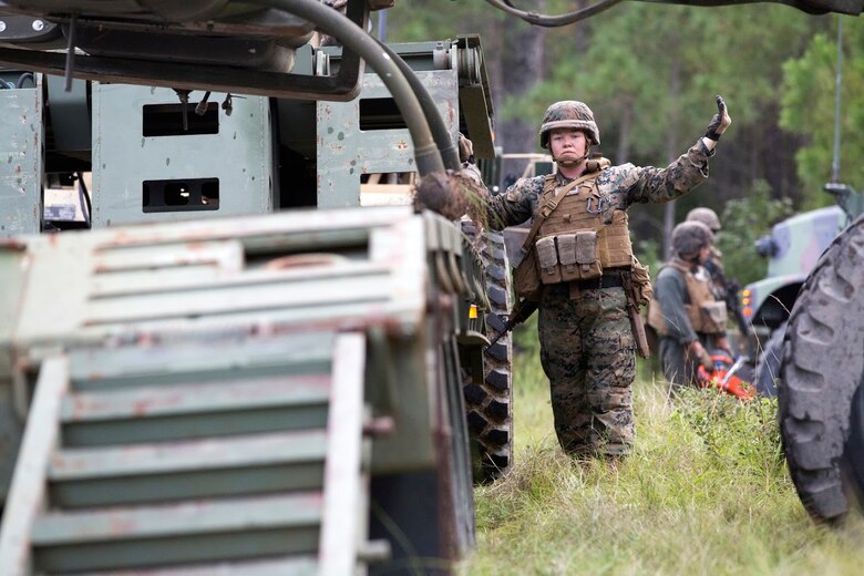 Sgt. Heather Foote directs a crane loading an aircraft during a field exercise aboard Marine Corps Outlying Field Camp Davis, N.C., Sept. 22, 2016. Support squadrons across the Marine Corps conduct these exercises to remain ready for any challenge they may face in forward deployed environments. This exercise featured training that included auxiliary airfield construction, ground security and airfield damage repair. The squadron's capabilities contribute to 2nd Marine Aircraft Wing's role in the Marine Air Ground Task Force's mission accomplishment. Foote is a motor vehicle operator assigned to Marine Wing Support Squadron 274, Marine Aircraft Group 29, 2nd MAW. (U.S. Marine Corps photo by Sgt. N.W. Huertas/Released) 