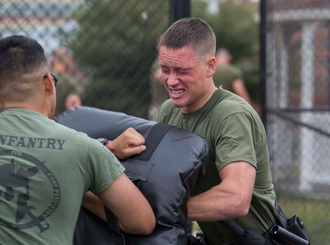 A Marine with Guard Company, Marine Barracks Washington, D.C., demonstrates martial arts strikes in an Oleoresin Capsicum (OC) spray evaluation course at the Barracks, Sept. 21, 2016. The OC spray course consists of a series of self-defense tactics and methods of detainment. (Official Marine Corps photo by Cpl. Andrianna Daly/Released)