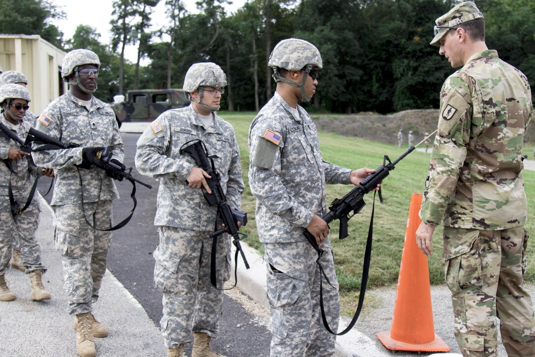 Soldiers wait in line for a safety check of their M4 carbines before they enter a weapons qualification range at Camp Smith, N.Y., Sept. 20, 2016. Army National Guard photo by Sgt. Michael Davis