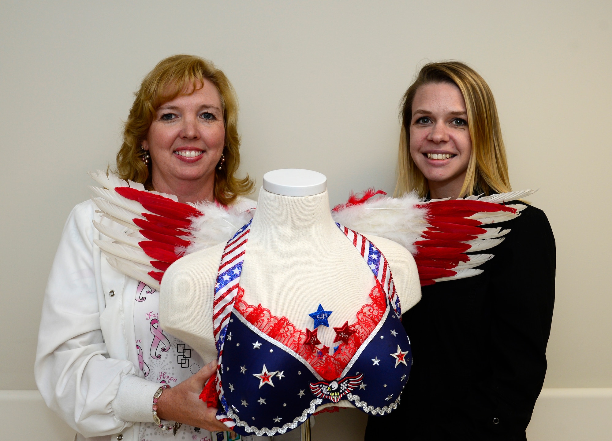 Wendy Elvis and Jamie Radik, 633rd Medical Group  mammography technologists, show off the bra they decorated for the Fill the Bra Campaign at Joint Base Langley-Eustis, Va., Sept. 21, 2016. The campaign, held in October for Breast Cancer Awareness Month, helps raise funds to provide healthcare to those uninsured and underinsured. (U.S. Air Force photo by Airman 1st Class Kaylee Dubois)