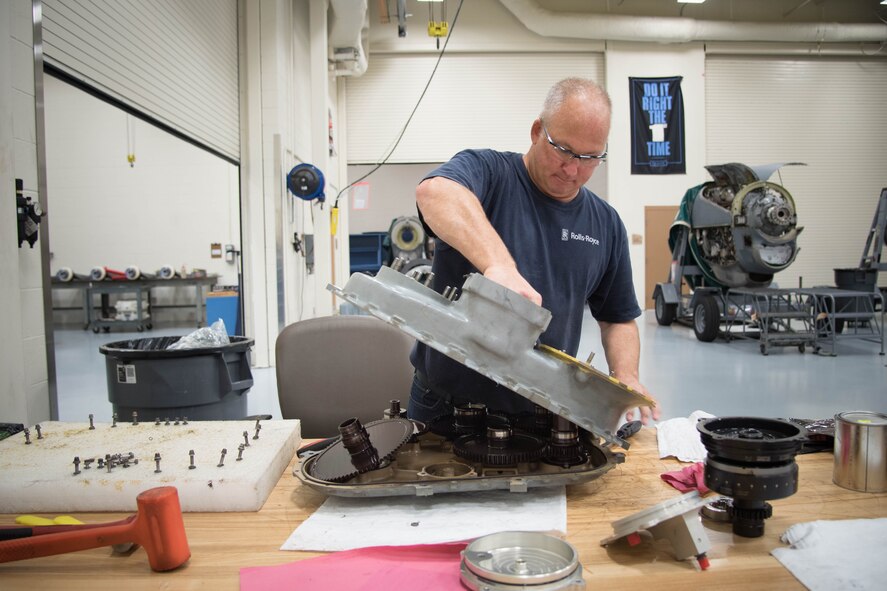 Frank Kraus, Rolls Royce airframe and power plant mechanic, opens up a gear mounted accessory drive before installing a new propeller brake. Rolls Royce employees are traveling from base to base working with Airmen for a fleet-wide upgrade of engines in every C-130J aircraft.(U.S. Air Force photo/Senior Airman Heather Heiney)