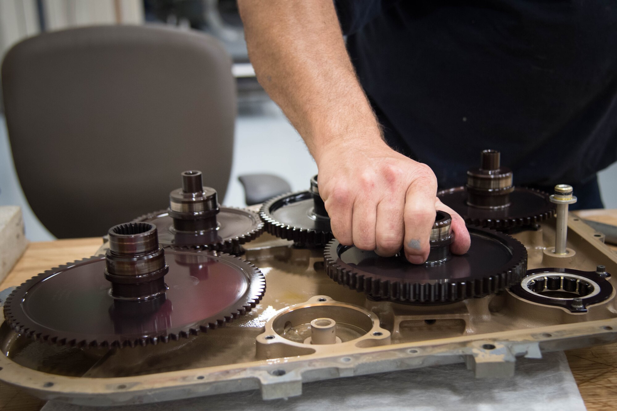 Frank Kraus, Rolls Royce airframe and power plant mechanic, inspects a gear mounted accessory drive before installing a new propeller brake. Rolls Royce employees are traveling from base to base working with Airmen for a fleet-wide upgrade of engines in every C-130J aircraft.(U.S. Air Force photo/Senior Airman Heather Heiney)