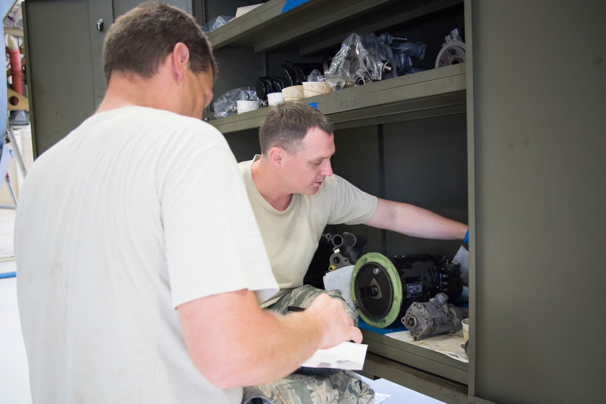 403rd Maintenance Squadron aerospace propulsion craftsmen, Tech Sgt. Joseph Griffin and Tech Sgt. Ben Cox look at parts needed to maintain a C-130J. Rolls Royce employees are traveling from base to base working with Airmen for a fleet-wide upgrade of engines in every C-130J aircraft.(U.S. Air Force photo/Senior Airman Heather Heiney)