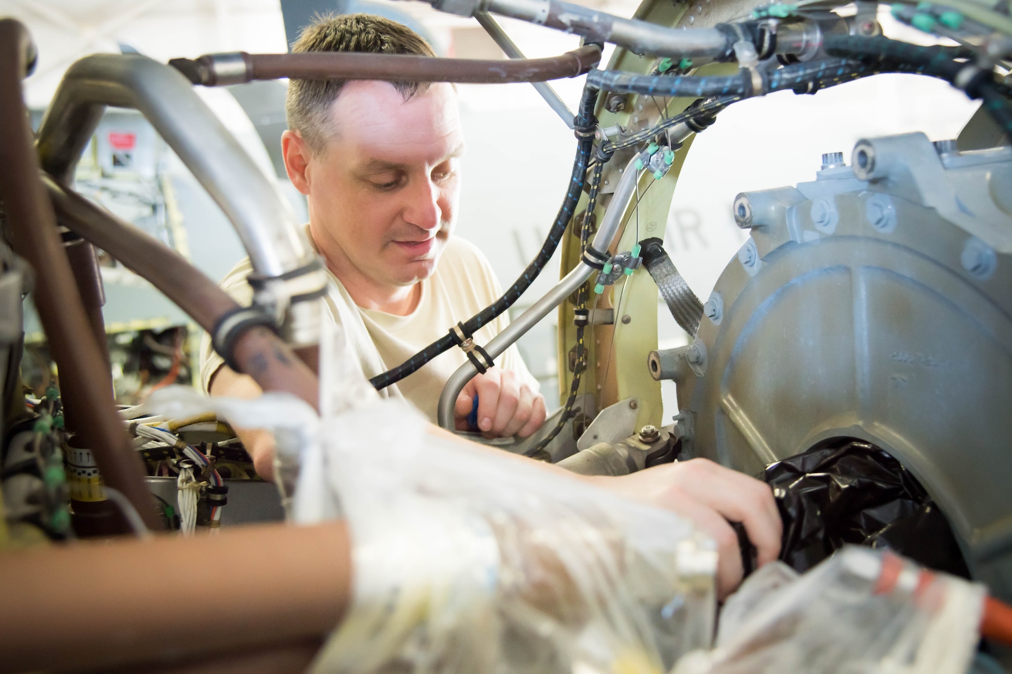 Tech Sgt. Joseph Griffin, 403rd Maintenance Squadron aerospace propulsion craftsman, inspects a C130J engine after its gear mounted accessory drive was removed for the installation of a propeller break. Rolls Royce employees are traveling from base to base working with Airmen for a fleet-wide upgrade of engines in every C-130J aircraft.(U.S. Air Force photo/Senior Airman Heather Heiney)