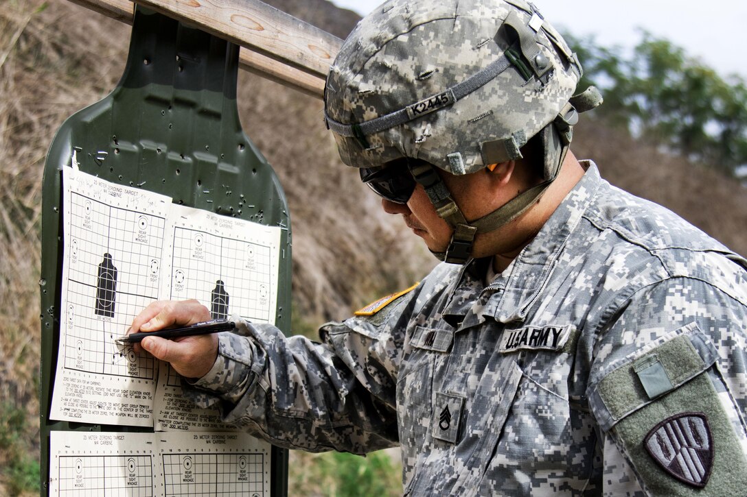 Army Staff Sgt. James Kim reviews his target after firing with an M4A1 carbine at Camp Smith, N.Y., Sept. 20, 2016. Kim is a quartermaster and chemical equipment repairer assigned to the New York Army National Guard’s 145th Maintenance Battalion. Army National Guard photo by Sgt. Michael Davis