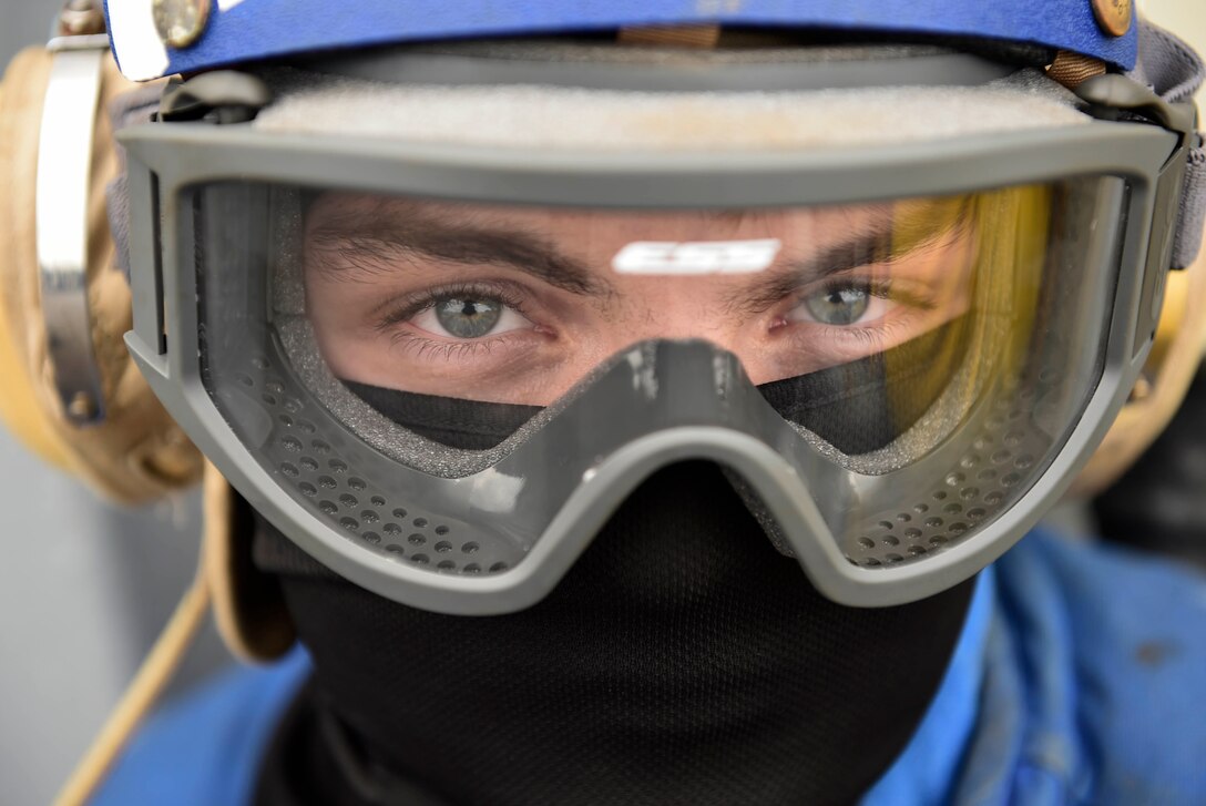 Navy Seaman Noah Cheeks dons a cranial helmet during flight operations aboard the USS Ross in the Mediterranean Sea, Sept. 24, 2016. The Ross, a guided-missile destroyer, is providing support in the Eastern Mediterranean as part of Operation Inherent Resolve. Navy photo by Petty Officer 1st Class Theron J. Godbold
