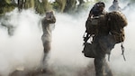 Marines don their gas masks as simulated hostiles use O-chlorobenzalmalononitrile gas (CS gas) during a raid as part of a training exercise aboard the Kahuku Training Facility, Sept. 20, 2016. The exercise is part of a 7-week-long training known as the Advance Infantry Course. The Advance Infantry Course, which is conducted by the Advance Infantry Battalion, Detachment Hawaii, is an advanced 0311 (Rifleman) Military Occupational Specialty course for squad leaders who are currently serving in the operating field. Originally only for 3rd Marine Division, the course here has opened up to various infantry units throughout the Marine Corps. Marines start with a week of proofing their prerequisites that are required for the course, confirming their basic skill sets, and then spend two weeks in a garrison environment doing course work and physical training routines geared toward the squad leader. Towards the second half of the course, Marines conduct one live fire week, followed by three consecutive weeks in the field, progressing from an urban exercise to a patrolling exercise, with offensive and defensive tactics. Marines trained in multiple areas on the island, from high in the mountains of the Kahuku Training Facility to the Military Operation in Urban Terrain facilities on Marine Corps Training Area Bellows. 