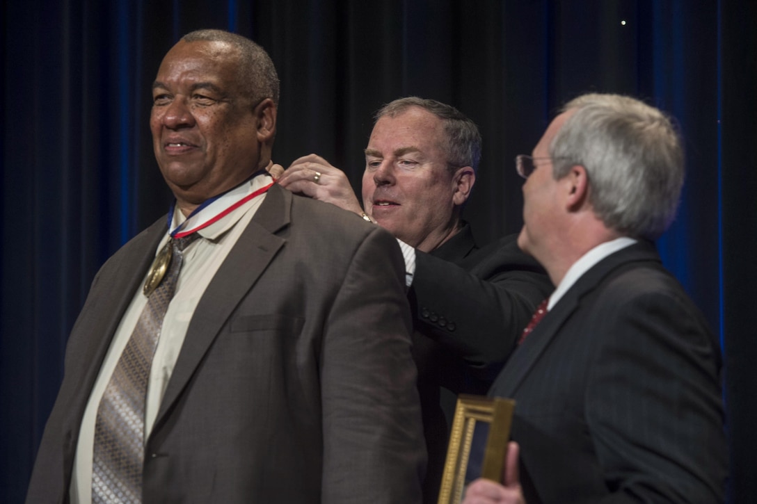 Deputy Defense Secretary Bob Work presents the Spirit of Hope Award to Timothy Bryant, commander of Veterans of Foreign Wars Post 3000, at the Pentagon, Sept. 28, 2016. Six individuals and one organization received the award, named after Bob Hope, for their service and commitment to the U.S. military. DoD photo by Navy Petty Officer 1st Class Tim D. Godbee