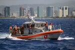 U.S. Coast Guardsmen from Coast Guard Station Honolulu transport members of the Honolulu Police Department Specialized Services Division aboard a 45-foot Response Boat-Medium offshore of Honolulu, Sept. 26, 2016. Station Honolulu served as a platform for HPD to conduct underway ship-boarding exercises aboard the Star of Honolulu. 