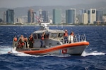 U.S. Coast Guardsmen from Coast Guard Station Honolulu transport members of the Honolulu Police Department Specialized Services Division aboard a 45-foot Response Boat-Medium offshore of Honolulu, Sept. 26, 2016. Station Honolulu served as a platform for HPD to conduct underway ship-boarding exercises aboard the Star of Honolulu. 