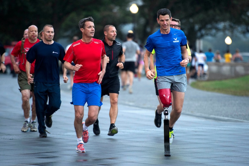 Crown Prince Frederik of Denmark, front left, leads a run with retired Air Force Tech. Sgt. Adam Popp at the National Mall in Washington, Sept. 28, 2016. Frederik and wounded veterans from Denmark and the United States ran 3.8 miles around the National Mall. DoD photo by EJ Hersom