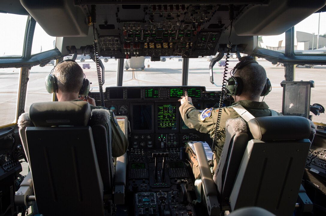U.S. Air Force Col. Thomas Kunkel, 23d Wing commander and Maj. Eric Lipp, 71st Rescue Squadron HC-130J Combat King II evaluator pilot,  review their pre-flight checklists prior to take-off, Sept. 27, 2016, at Moody Air Force Base, Ga. The HC-130J’s mission is to rapidly deploy and execute combatant commander directed operations. (U.S. Air Force photo by Airman 1st Class Greg Nash)
