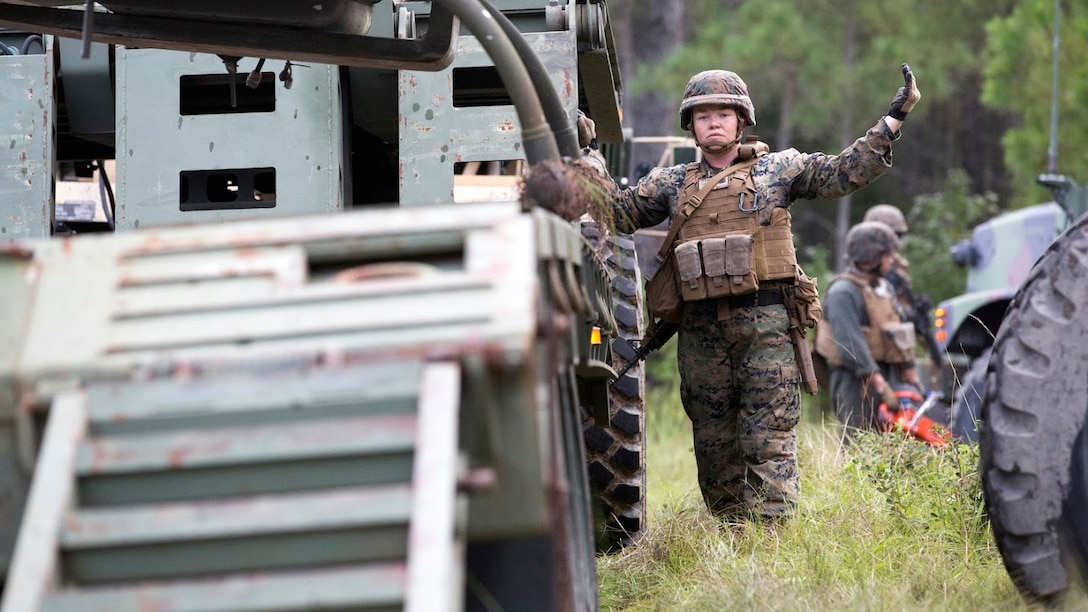 Sgt. Heather Foote directs a crane loading an aircraft during a field exercise aboard Marine Corps Outlying Field Camp Davis, N.C., Sept. 22, 2016. Support squadrons across the Marine Corps conduct these exercises to remain ready for any challenge they may face in forward deployed environments. This exercise featured training that included auxiliary airfield construction, ground security and airfield damage repair. The squadron's capabilities contribute to 2nd Marine Aircraft Wing's role in the Marine Air Ground Task Force's mission accomplishment. Foote is a motor vehicle operator assigned to Marine Wing Support Squadron 274, Marine Aircraft Group 29, 2nd MAW. 