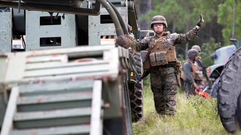 Sgt. Heather Foote directs a crane loading an aircraft during a field exercise aboard Marine Corps Outlying Field Camp Davis, N.C., Sept. 22, 2016. Support squadrons across the Marine Corps conduct these exercises to remain ready for any challenge they may face in forward deployed environments. This exercise featured training that included auxiliary airfield construction, ground security and airfield damage repair. The squadron's capabilities contribute to 2nd Marine Aircraft Wing's role in the Marine Air Ground Task Force's mission accomplishment. Foote is a motor vehicle operator assigned to Marine Wing Support Squadron 274, Marine Aircraft Group 29, 2nd MAW. 