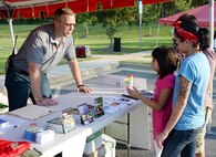 MCLB Albany Emergency Manager Steven Dancer speaks to a family about the Installation Mass Notification and Warning System during the 2nd Annual MCLB Albany Preparedness Fair. The event drew 20 families, which represents about 20 percent of the installation's housing community. Photo by Nathan Hanks, MCLB Albany PAO  