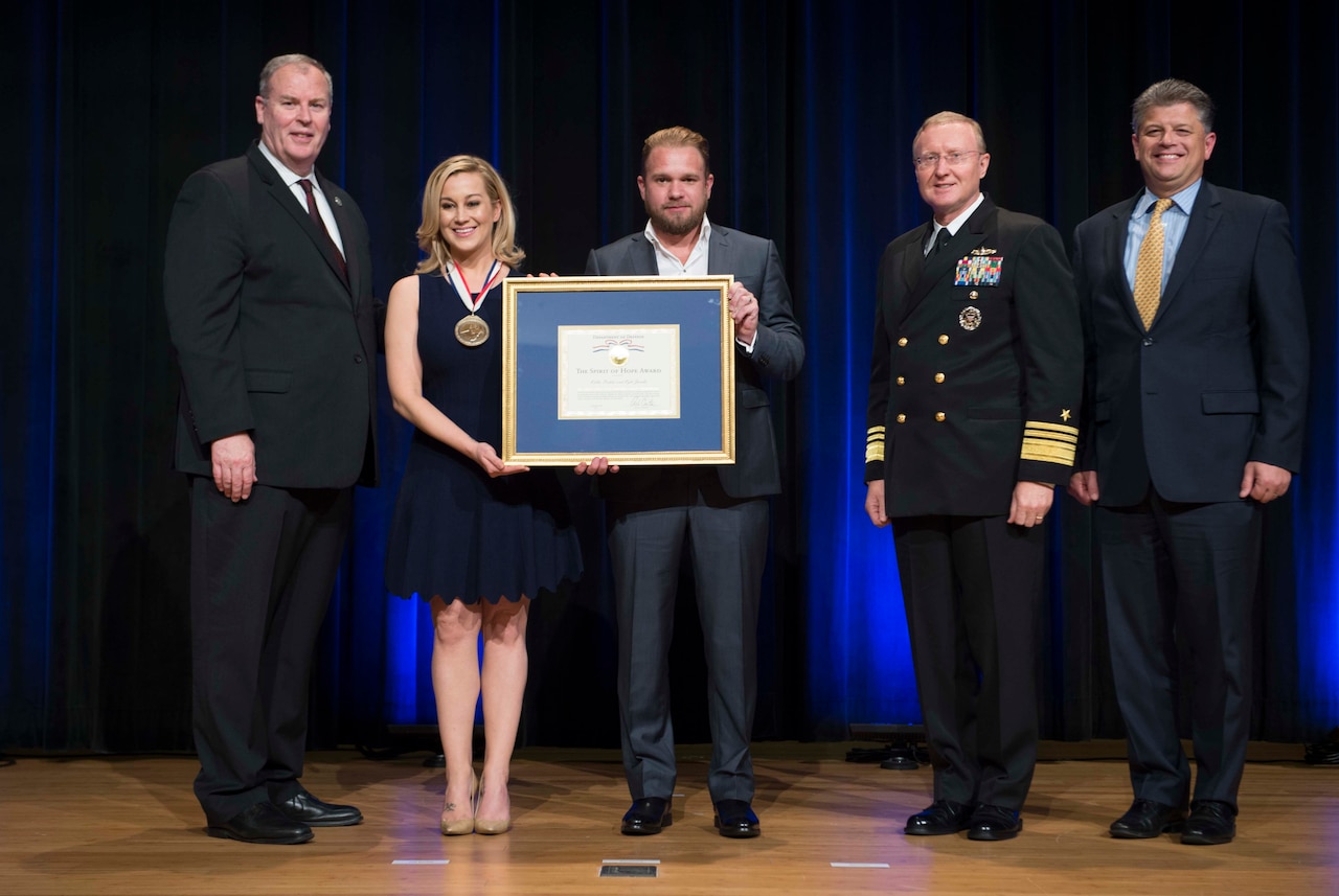 Deputy Defense Secretary  Bob Work presents the Spirit of Hope Award to singer Kellie Pickler and her songwriter-musician husband, Kyle Jacobs, at the Pentagon,Sept. 28, 2016. They were among the six individuals and one organization honored for their dedication to supporting the troops, in the spirit of the award's namesake, legendary entertainer Bob Hope. DoD photo by Navy Petty Officer 1st Class Tim D. Godbee