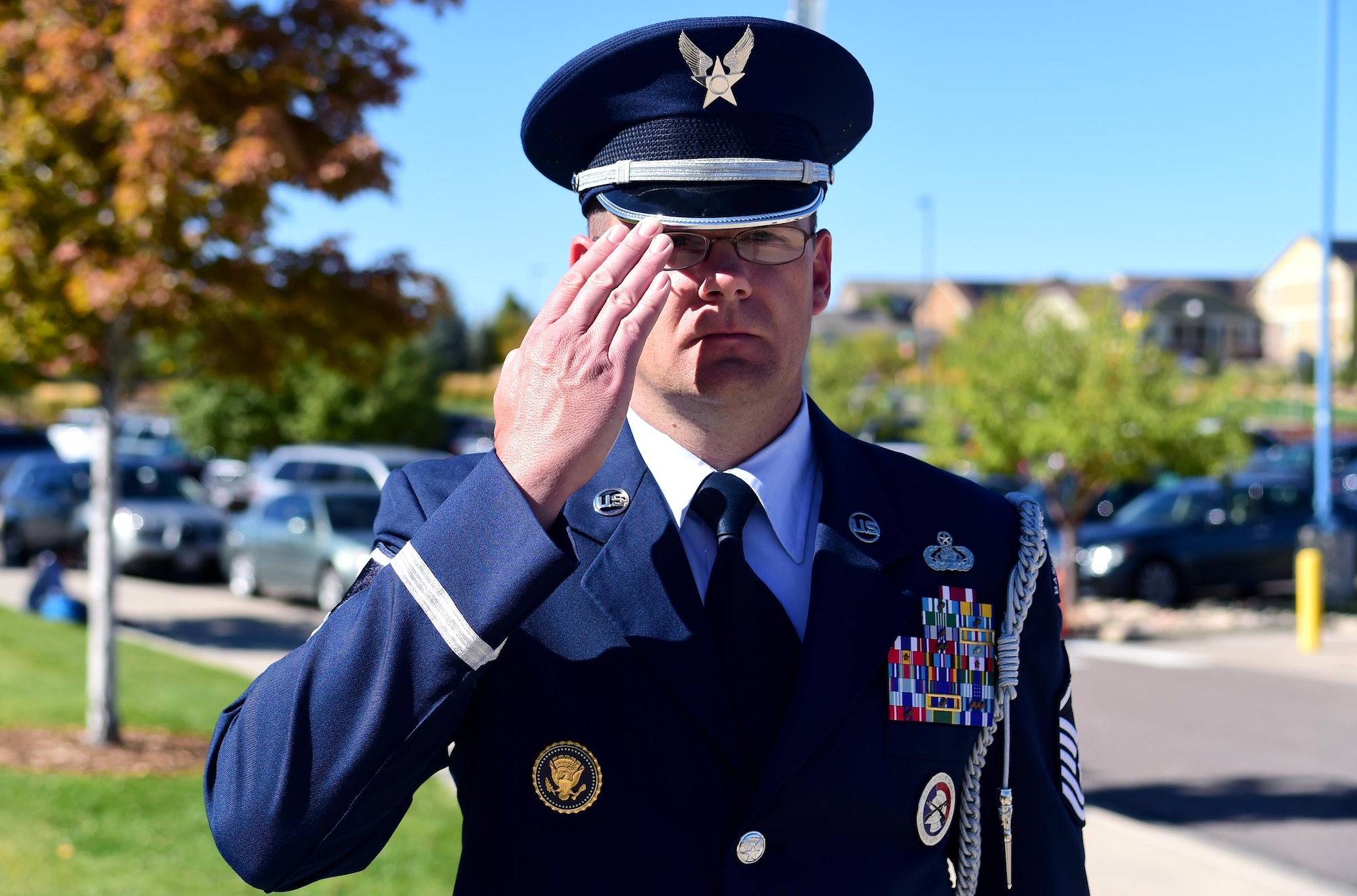 Master Sgt. Michael Rutherford, U.S. Air Force Mile High Honor Guard superintendent, renders a salute to the American flag Sep. 27, 2016, at Aurora Frontier P-8 in Aurora, Colo. While it is common for civilians to hold their right hand over their heart, rendering a salute has become a courtesy for men and women in the armed forces. (U.S. Air Force photo by Airman Holden S. Faul/ Released) 