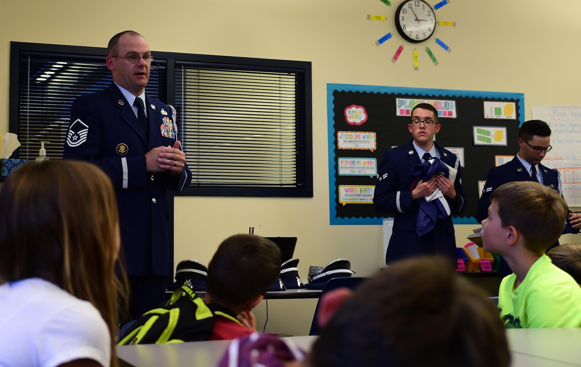 Master Sgt. Michael Rutherford, U.S. Air Force Mile High Honor Guard superintendent, answers questions about properly lowering and folding the American flag Sep. 27, 2016, at Aurora Frontier P-8 in Aurora, Colo. Students raise and lower the flag each day at Aurora Frontier P-8 and the honor guard came out to further educate them on its importance and process. (U.S. Air Force photo by Airman Holden S. Faul/ Released) 