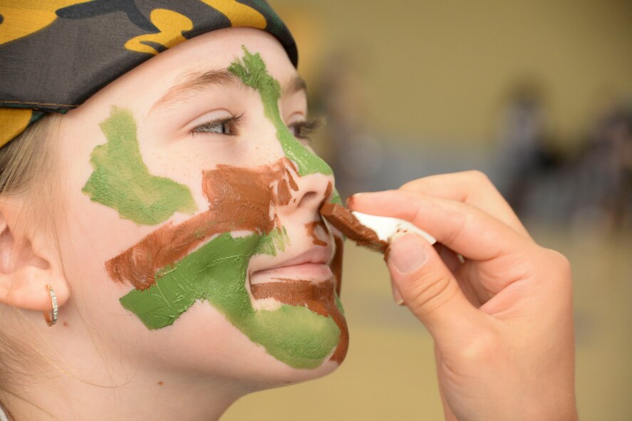 An Operation Hero recruit gets her face painted during Operation Hero 2016 at Barksdale Air Force Base, La., Sept. 24. The annual event allows children to have a better understanding of what Airmen go through before deploying. Along with running through a personnel deployment function line the recruits got their faces painted, tasted meals-ready-to-eat and learned about real world events that military members face every day. (U.S. Air Force photo/Senior Airman Amanda Morris)