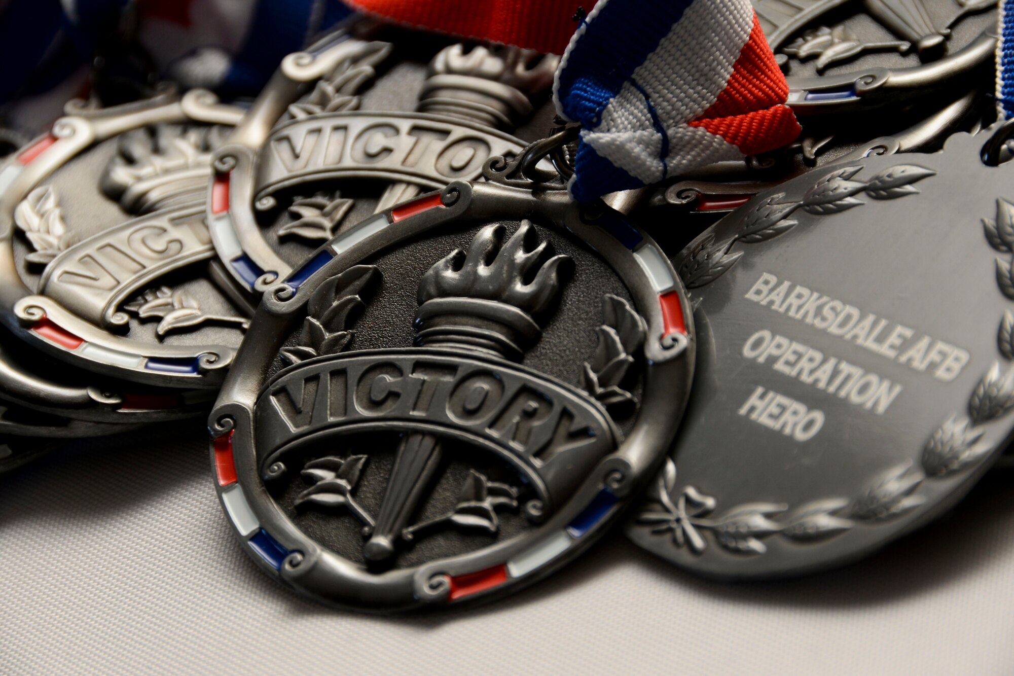 Medals represent an Operation Hero recruits completion of Operation Hero 2016 at Barksdale Air Force Base, La., Sept. 24. Operation Hero is an annual event for children to participate in a mock deployment line. The event allows them to have a better understanding of what Airmen go through before deploying. (U.S. Air Force photo/Senior Airman Amanda Morris) 