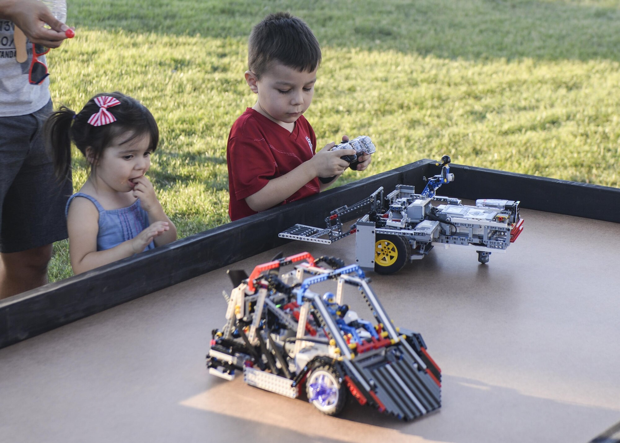 A child plays with a remote-controlled car during the annual Zoo after Hours event at Alameda Park Zoo in Alamogordo, N.M. on Sept. 24, 2016. The cars were an interactive part of Otero STEM’s booth. Otero STEM is a local organization dedicated to promoting education in science, technology, engineering and mathematics. (U.S.  Air Force photo by Airman 1st Class Alexis P. Docherty)