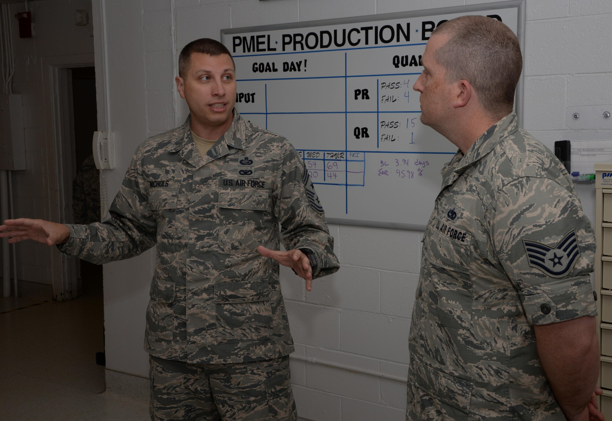 Chief Master Sgt. Steve Nichols (Left), 60th Air Mobility Wing command chief, enjoys a conversation with Staff Sgt. Timothy Gould (Right), 60th Maintenance Squadron precision measurement equipment laboratory technician from Buffalo, New York, before presenting Gould with his coin at Travis Air Force Base, Calif., Sept. 27, 2016. Gould was recognized for his efforts as a master resiliency training instructor. He has helped provide resiliency training to more than 800 Airmen in 2016. (U.S. Air Force photo/Tech. Sgt. James Hodgman)