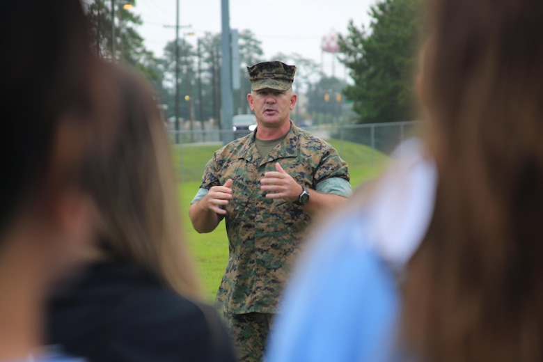 Sgt. Maj. John Elliott addresses the spouses of Marines with Marine Aircraft Group 29 before beginning “Marine for a Day,” an event hosted aboard Marine Corps Air Station New River, N.C., Sept. 23, 2016. The purpose of the event was to give spouses a better perspective of the mental and physical demands their Marines go through on a day-to-day basis in order to maintain their personal readiness. The event included hands-on practice at the Indoor Simulated Marksmanship Trainer, a tour of the various aircraft aboard the air station, Marine Corps Martial Arts Program familiarization, a combat fitness test and more. Elliott is the sergeant major for MAG-29, 2nd Marine Aircraft Wing. (U.S. Marine Corps photo by Lance Cpl. Mackenzie Gibson/Released)
