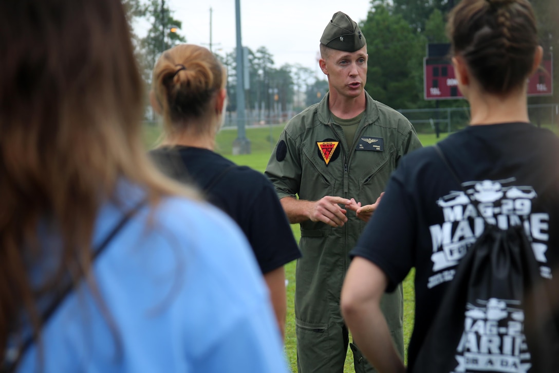 Lt. Col. William Hendricks addresses the spouses of Marines with Marine Aircraft Group 29 before beginning “Marine for a Day,” an event hosted aboard Marine Corps Air Station New River, N.C., Sept. 23, 2016. The purpose of the event was to give spouses a better perspective of the mental and physical demands their Marines go through on a day-to-day basis in order to maintain their personal readiness. The event included hands-on practice at the Indoor Simulated Marksmanship Trainer, a tour of the various aircraft aboard the air station, Marine Corps Martial Arts Program familiarization, a combat fitness test and more. Hendricks is the executive officer for MAG-29, 2nd Marine Aircraft Wing. (U.S. Marine Corps photo by Lance Cpl. Mackenzie Gibson/Released)