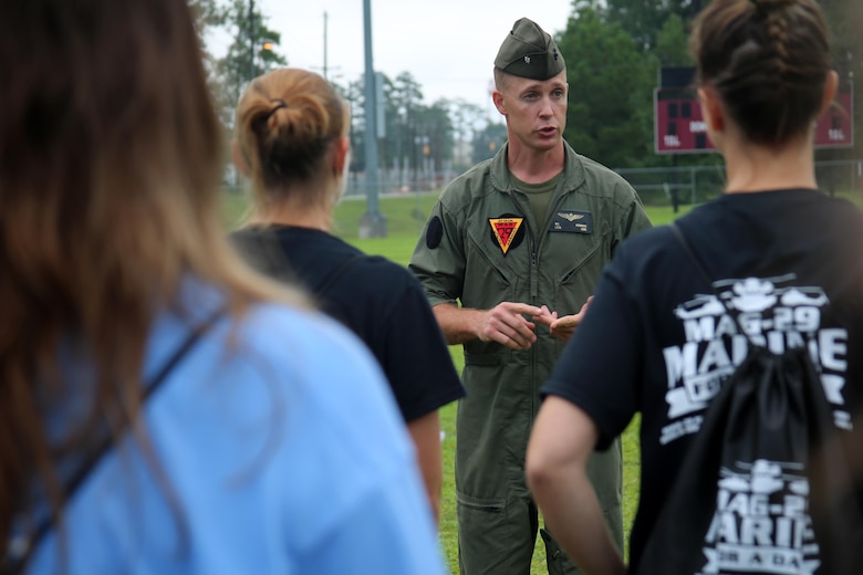 Lt. Col. William Hendricks addresses the spouses of Marines with Marine Aircraft Group 29 before beginning “Marine for a Day,” an event hosted aboard Marine Corps Air Station New River, N.C., Sept. 23, 2016. The purpose of the event was to give spouses a better perspective of the mental and physical demands their Marines go through on a day-to-day basis in order to maintain their personal readiness. The event included hands-on practice at the Indoor Simulated Marksmanship Trainer, a tour of the various aircraft aboard the air station, Marine Corps Martial Arts Program familiarization, a combat fitness test and more. Hendricks is the executive officer for MAG-29, 2nd Marine Aircraft Wing. (U.S. Marine Corps photo by Lance Cpl. Mackenzie Gibson/Released)