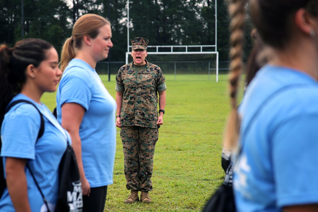 Sgt. Maj. Paulette Newcomb leads drill for Marine spouses during the drill portion of “Marine for a Day,” an event hosted by Marine Aircraft Group 29 aboard Marine Corps Air Station New River, N.C., Sept. 23, 2016. The purpose of the event was to give spouses a better perspective of the mental and physical demands their Marines go through on a day-to-day basis in order to maintain their personal readiness. The event included hands-on practice at the Indoor Simulated Marksmanship Trainer, a tour of the various aircraft aboard the air station, Marine Corps Martial Arts Program familiarization, a combat fitness test and more. Newcomb is the sergeant major for Marine Heavy Helicopter Squadron 464. (U.S. Marine Corps photo by Lance Cpl. Mackenzie Gibson/Released)