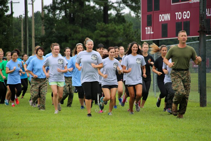 Sgt. Maj. James D. VonDras leads a formation of spouses of Marines with Marine Aircraft Group 29 during “Marine for a Day,” an event hosted aboard Marine Corps Air Station New River, N.C., Sept. 23, 2016. The purpose of the event was to give spouses a better perspective of the mental and physical demands their Marines go through on a day-to-day basis in order to maintain their personal readiness. The event included hands-on practice at the Indoor Simulated Marksmanship Trainer, a tour of the various aircraft aboard the air station, Marine Corps Martial Arts Program familiarization, a combat fitness test and more. VonDras is the sergeant major for Marine Heavy Helicopter Squadron 461. (U.S. Marine Corps photo by Lance Cpl. Mackenzie Gibson/Released)