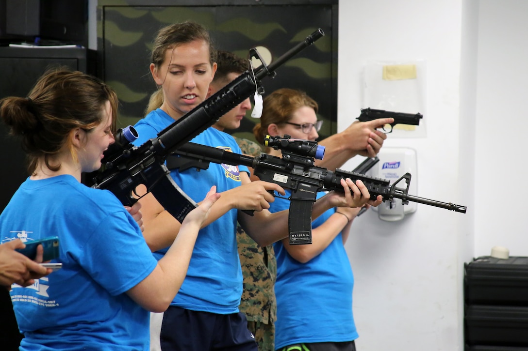 Spouses of Marines with Marine Aircraft Group 29 use the Indoor Simulated Marksmanship Trainer during “Marine for a Day,” an event hosted at Marine Corps Air Station New River, N.C., Sept. 23, 2016. The purpose of the event was to give spouses a better perspective of the mental and physical demands their Marines go through on a day-to-day basis in order to maintain their personal readiness. The event included hands-on practice at the Indoor Simulated Marksmanship Trainer, a tour of the various aircraft aboard the air station, Marine Corps Martial Arts Program familiarization, a combat fitness test and more. (U.S. Marine Corps photo by Lance Cpl. Mackenzie Gibson/Released)
