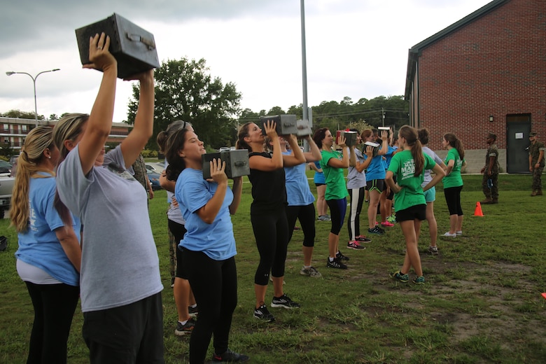 A spouse of a Marine with Marine Aircraft Group 29 low crawls for the Marine Corps combat fitness test during “Marine for a Day,” an event hosted at Marine Corps Air Station New River, N.C., Sept. 23, 2016. The purpose of the event was to give spouses a better perspective of the mental and physical demands their Marines go through on a day-to-day basis in order to maintain their personal readiness. The event included hands-on practice at the Indoor Simulated Marksmanship Trainer, a tour of the various aircraft aboard the air station, Marine Corps Martial Arts Program familiarization, a combat fitness test and more. (U.S. Marine Corps photo by Lance Cpl. Mackenzie Gibson/Released)