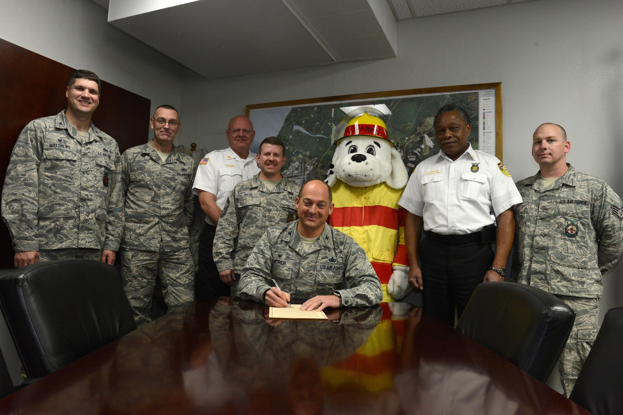 Air Force Col. George T. M. Dietrich III, Joint Base Elmendorf-Richardson and 673d Air Base Wing commander, signs the National Fire Prevention Week proclamation at JBER, Alaska, Sept. 28, 2016. The National Fire Prevention Week campaign promotes better education about the importance of keeping smoke alarms up to date. 