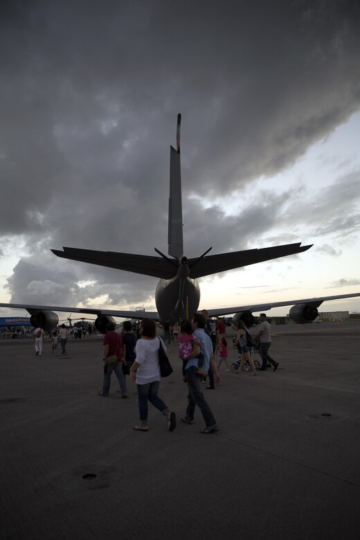 Guests of the Futenma Flight Line Fair view and take photos of a KC-135 Sept. 24 at Marine Corps Air Station Futenma, Okinawa, Japan. This aircraft was one of many large static displays from both the Marines Corps and the U.S. Air Force. Pilots and aircrew members posed for photos with guests and answered questions about the aircraft, their jobs and their daily lives as service members. MCAS Futenma opened its flight line to Status of Forces Agreement Personnel and Okinawa residents as they enjoyed local vendors, games and a performance by The Band Perry.