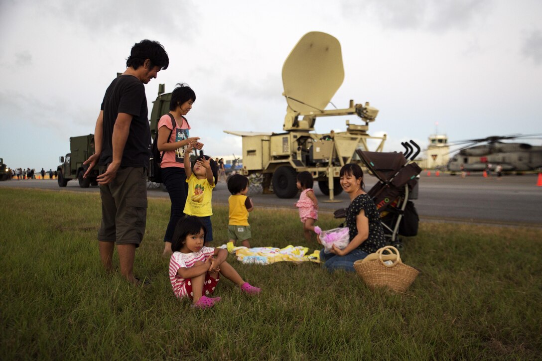 A family from Ginowan City has a picnic Sept. 24 during the Flight Line Fair on Marine Corps Air Station Futenma, Okinawa, Japan. MCAS Futenma opened its flight line to Status of Forces Agreement Personnel and Okinawa residents as they enjoyed local vendors, games and a performance by The Band Perry. The annual open-gate event strengthened the relationship between Status of Forces Agreement personnel and Okinawa residents and reeled in more than 30,000 attendees.