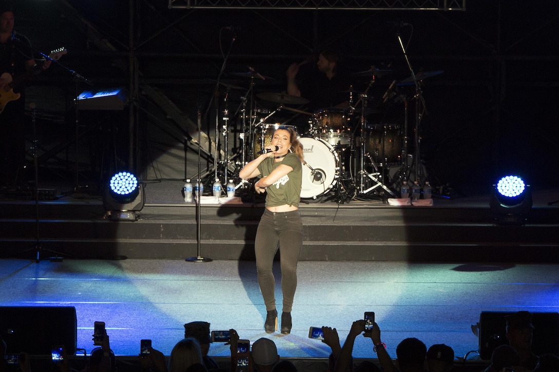Kimberly Perry, the lead vocalist of The Band Perry, sings onstage Sept. 24 during the Flight Line Fair at Marine Corps Air Station Futenma, Okinawa, Japan. MCAS Futenma opened its flight line to Status of Forces Agreement Personnel and Okinawa residents as they enjoyed local vendors, games and a performance by The Band Perry. The Band Perry is an American country group featuring siblings Kimberly, Neil and Reid Perry.  Perry thanked the audience for their sacrifices overseas and said she felt honored to be able to perform for them.