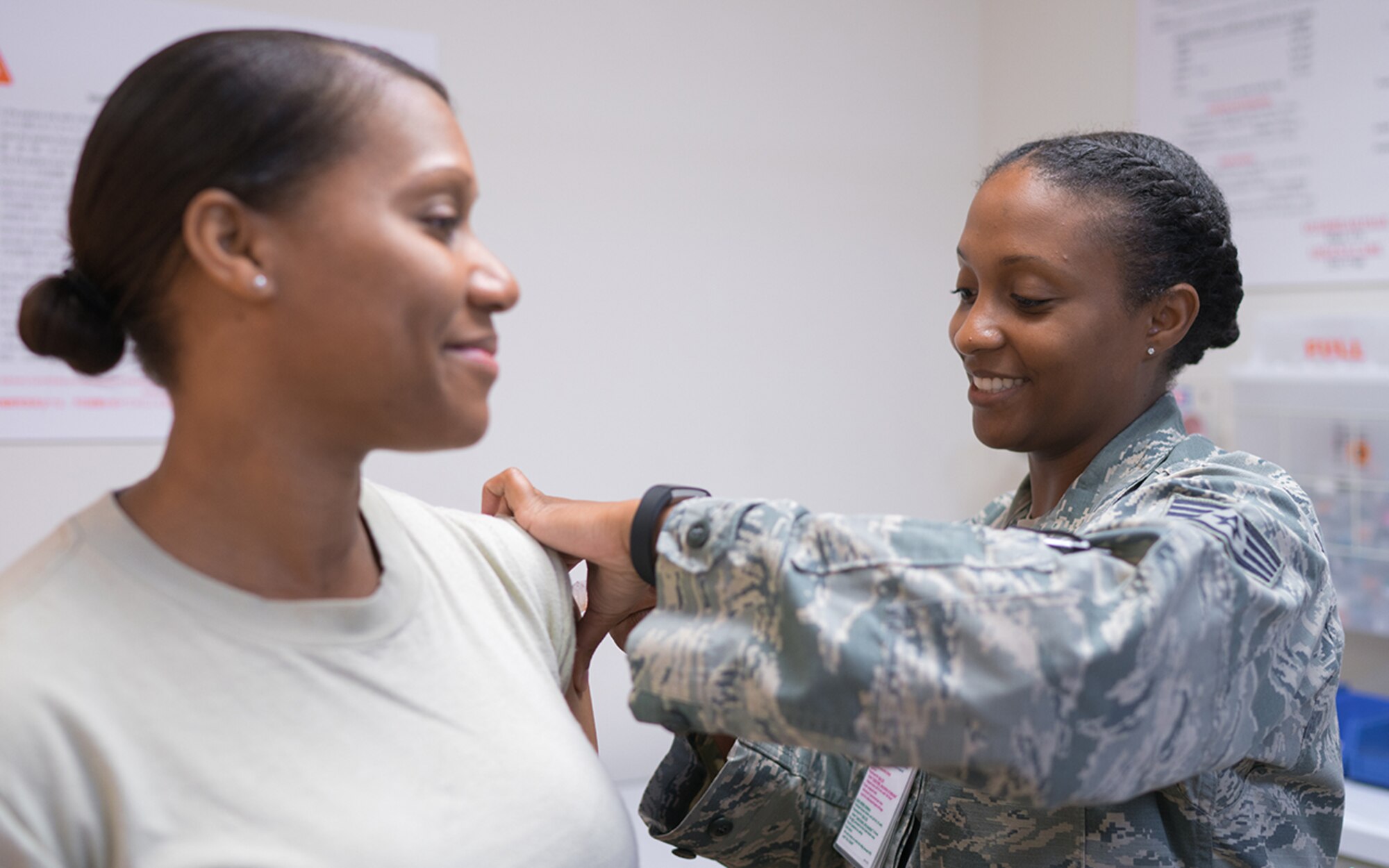 Staff Sgt. Melissa Spicer, 374th Medical Group allergy and immunization clinic technician, administers an influenza vaccination shot at Yokota Air Base, Japan, Sept. 27, 2016. The seasonal flu vaccine protects against the influenza viruses that research indicates will be most common during the upcoming season by causing your body to develop antibodies against these viruses. (U.S. Air Force photo by Senior Airman Delano Scott/Released)