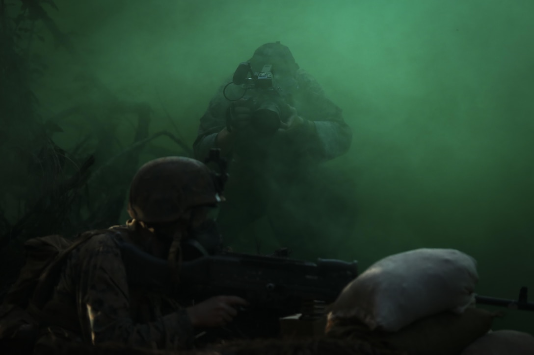 U.S. Marine Corps Lance Cpl. Brendon Custer, a combat videographer with Headquarters Battalion, Marine Corps Base Hawaii, records video during the Advanced Infantry Course (AIC) aboard Kahuku Training Area, Sept. 20, 2016. AIC is intermediate training designed to enhance and test the Marine's skills and leadership abilities as squad leaders in a rifle platoon. (U.S. Marine Corps Photo by Cpl. Aaron S. Patterson)