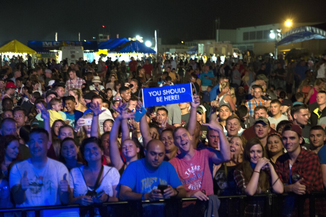 The crowd eagerly awaits a live, free concert Sept. 24 during the Flight Line Fair at Marine Corps Air Station Futenma, Okinawa, Japan. The annual open-gate event strengthened the relationship between Status of Forces Agreement personnel and Okinawa residents and reeled in more than 30,000 attendees. The event ushered in more than 30 thousand guests who enjoyed a vast array of ethnic foods, games and musical performances, headlined by The Band Perry, an American country music group.