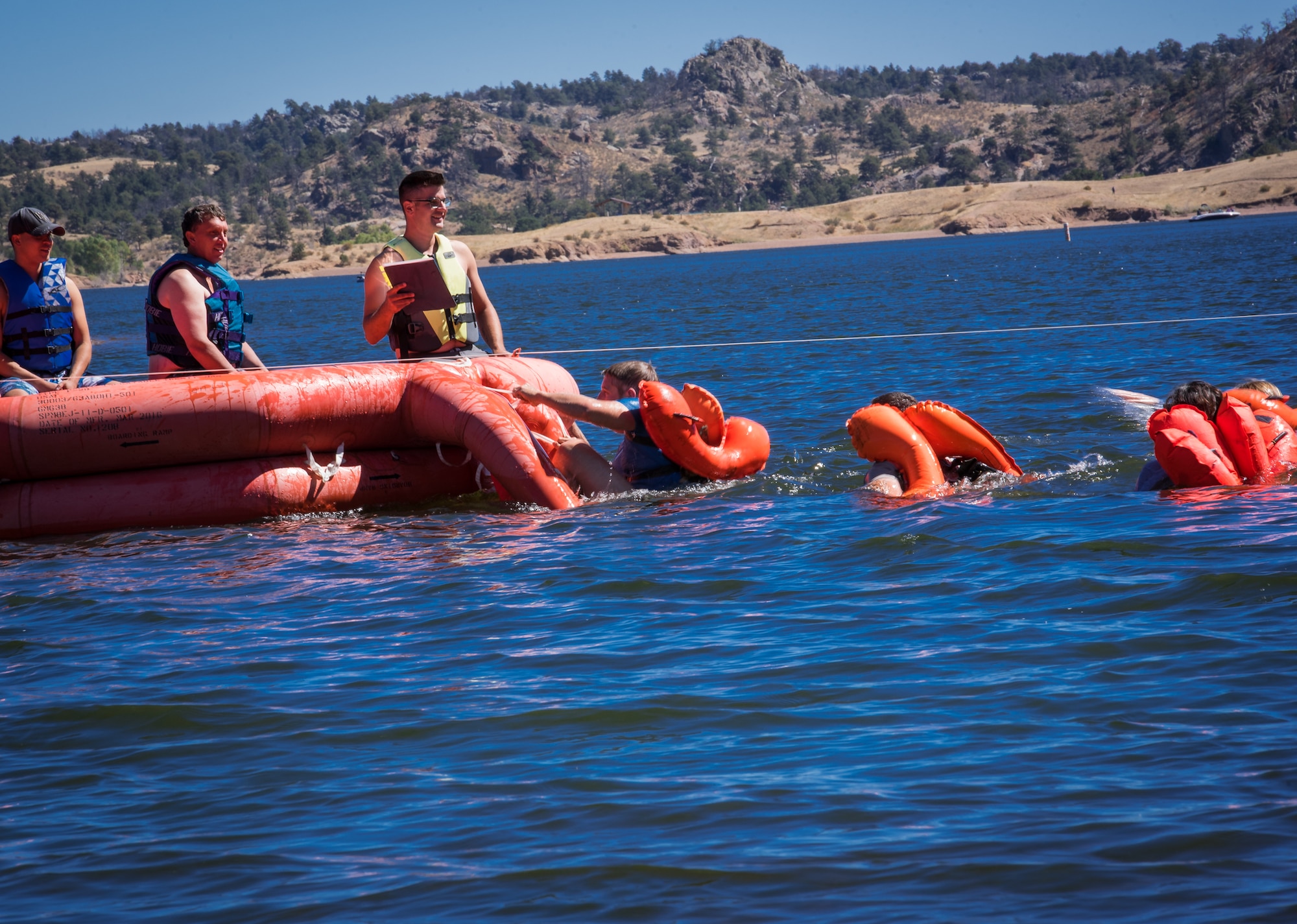 U.S. Air Force airmen assigned to the 153rd Airlift Wing, Wyoming Air National Guard board a 20-man life raft during water survival training Sept 10, 2016, at Curt Gowdy state park, Cheyenne, Wyoming. Aircrew flight equipment instructors recertify aircrew members water survival skills every three years.  (U.S. Air National Guard photo by Tech. Sgt. John Galvin)