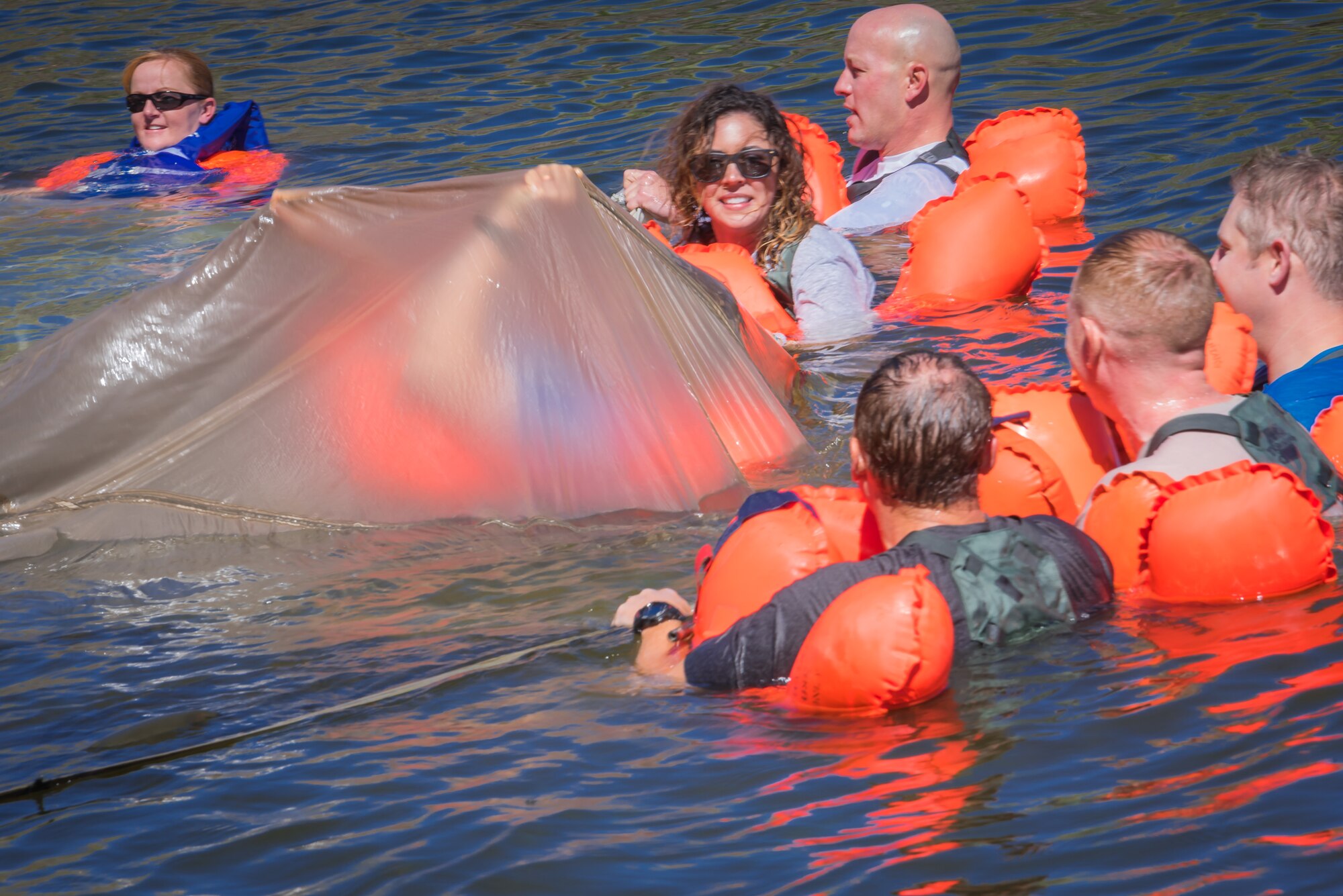 U.S. Air Force airmen assigned to the 153rd Airlift Wing, Wyoming Air National Guard practice maneuvering out from under a downed canopy during water survival training Sept 10, 2016, at Curt Gowdy state park, Cheyenne, Wyoming. Aircrew flight equipment instructors recertify aircrew members water survival skills every three years.  (U.S. Air National Guard photo by Tech. Sgt. John Galvin)