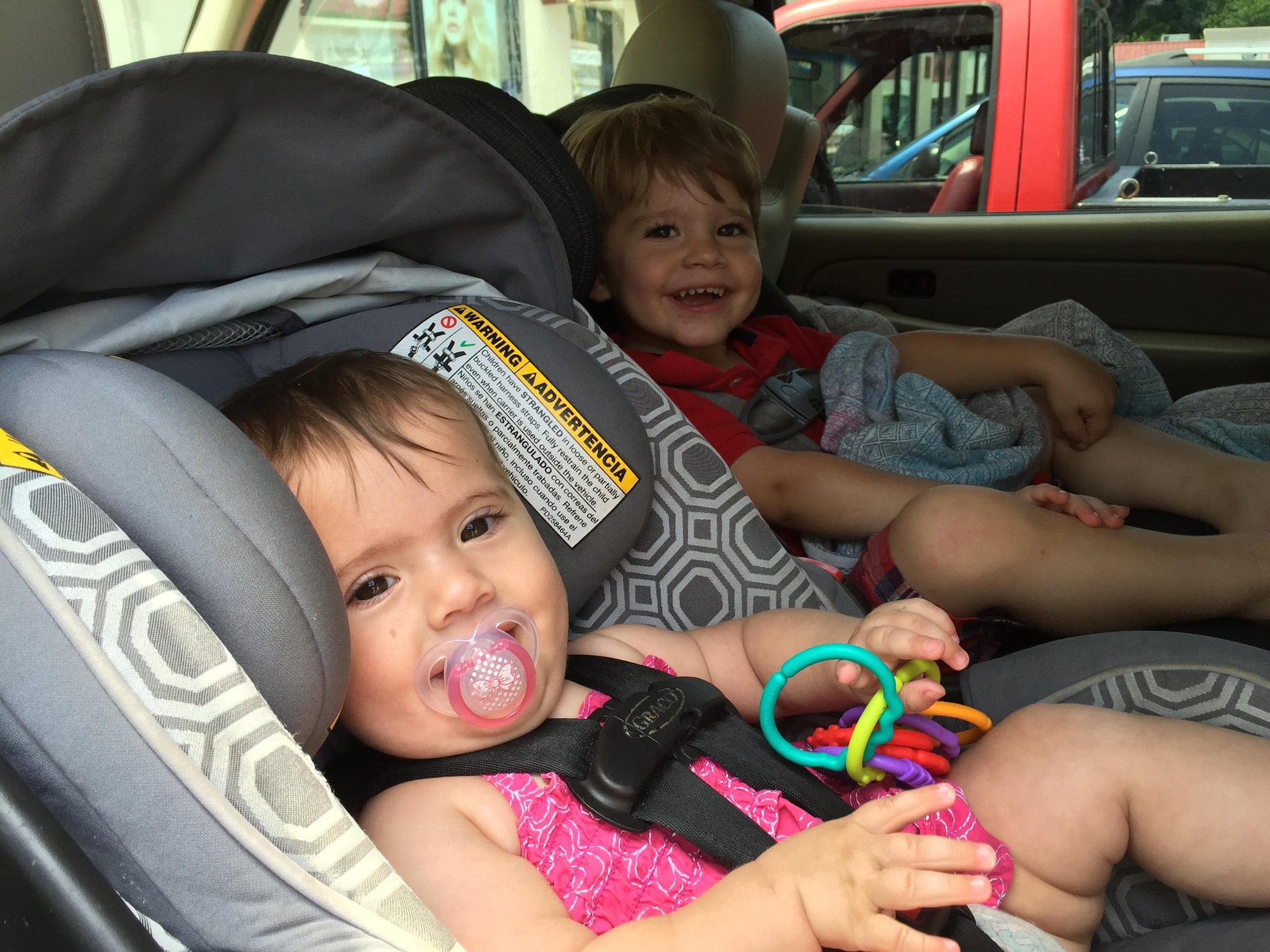 Two young children, ages nine months and 30 months, sit comfortably rear-facing in their car seats. The American Association of Pediatrics recommends children remain rear-facing for a minimum of two years. (U.S. Air Force photo/ W.C. Pope)