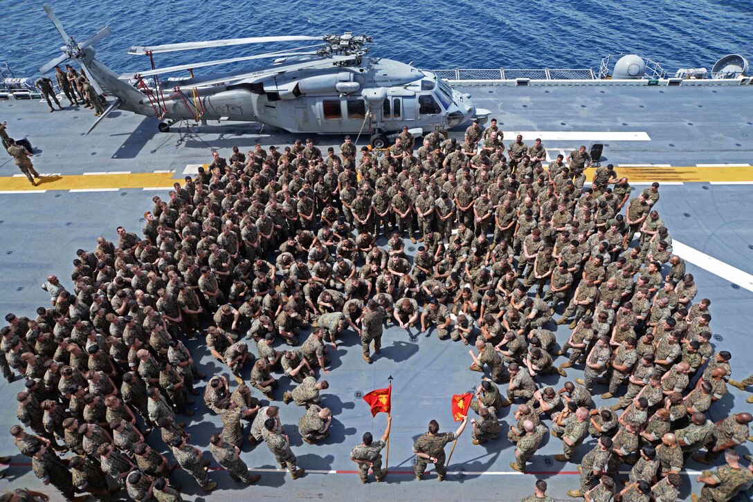 Navy Lt. Col. Brian Greene addresses a formation of Marines on the flight deck of the amphibious assault ship USS Bonhomme Richard in the Philippine Sea, Sept. 27, 2016. The Marines are assigned to 2nd Battalion, 4th Marine Regiment, 31st Marine Expeditionary Unit. The ship is supporting security and stability in the Indo-Asia-Pacific region. Navy photo by Petty Officer 2nd Class Sarah Villegas