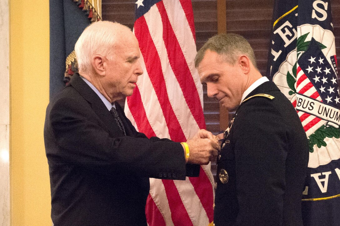 U.S. Sen. John McCain of Arizona pins a Soldier's Medal on Army Lt. Col. David P. Diamond during a ceremony on Capitol Hill, Sept. 27, 2016. Diamond received the medal for helping to save lives following the bombings at the Boston Marathon three years ago. Army photo by John Martinez