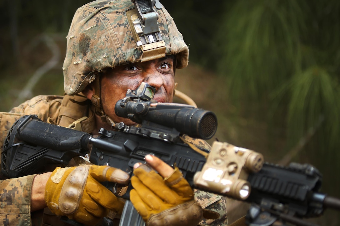 Marine Corps Lance Cpl. Anthony Acedo reacts to a surprise gas attack as part of the Advanced Infantry Course at Kahuku Training Area, Hawaii, Sept. 20, 2016. Acedo is a rifleman assigned to the 1st Battalion, 7th Marine Regiment. Marine Corps photo by Cpl. Aaron S. Patterson