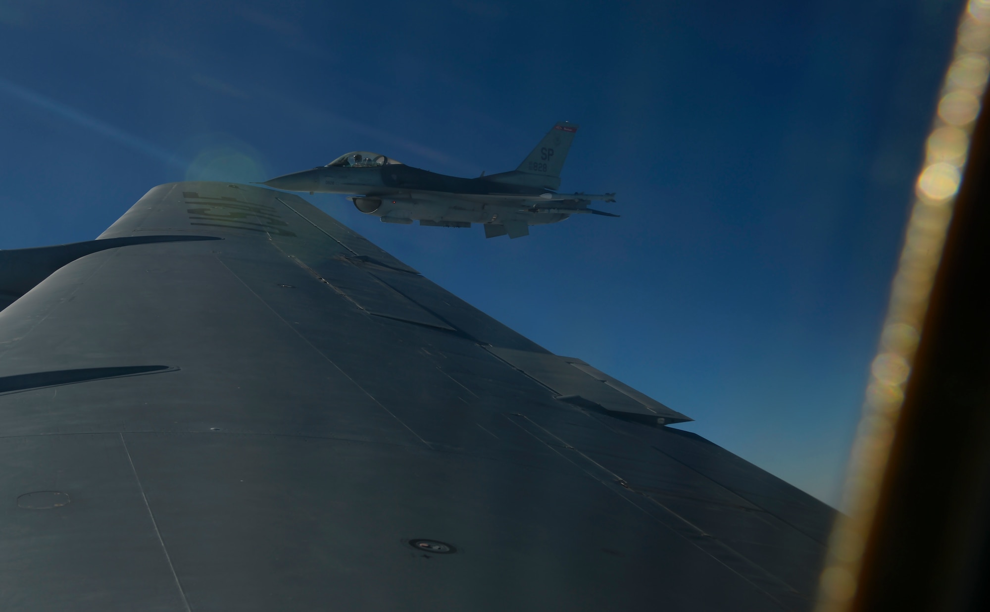 A U.S. Air Force F-16 Fighting Falcon assigned to the 52nd Fighter Wing flies past a KC-135 Stratotanker, assigned to the 191st Air Refueling Squadron, Roland R. Wright Air National Guard Base, Utah, over Ramstein Air Base, Sept. 27, 2016. The 191st ARS ANG unit conducted in-flight refueling exercise to demonstrate how tanker support can extend and prolong flight operations for U.S. and coalition aircraft. (U.S. Air Force photo/Senior Airman Dawn M. Weber)