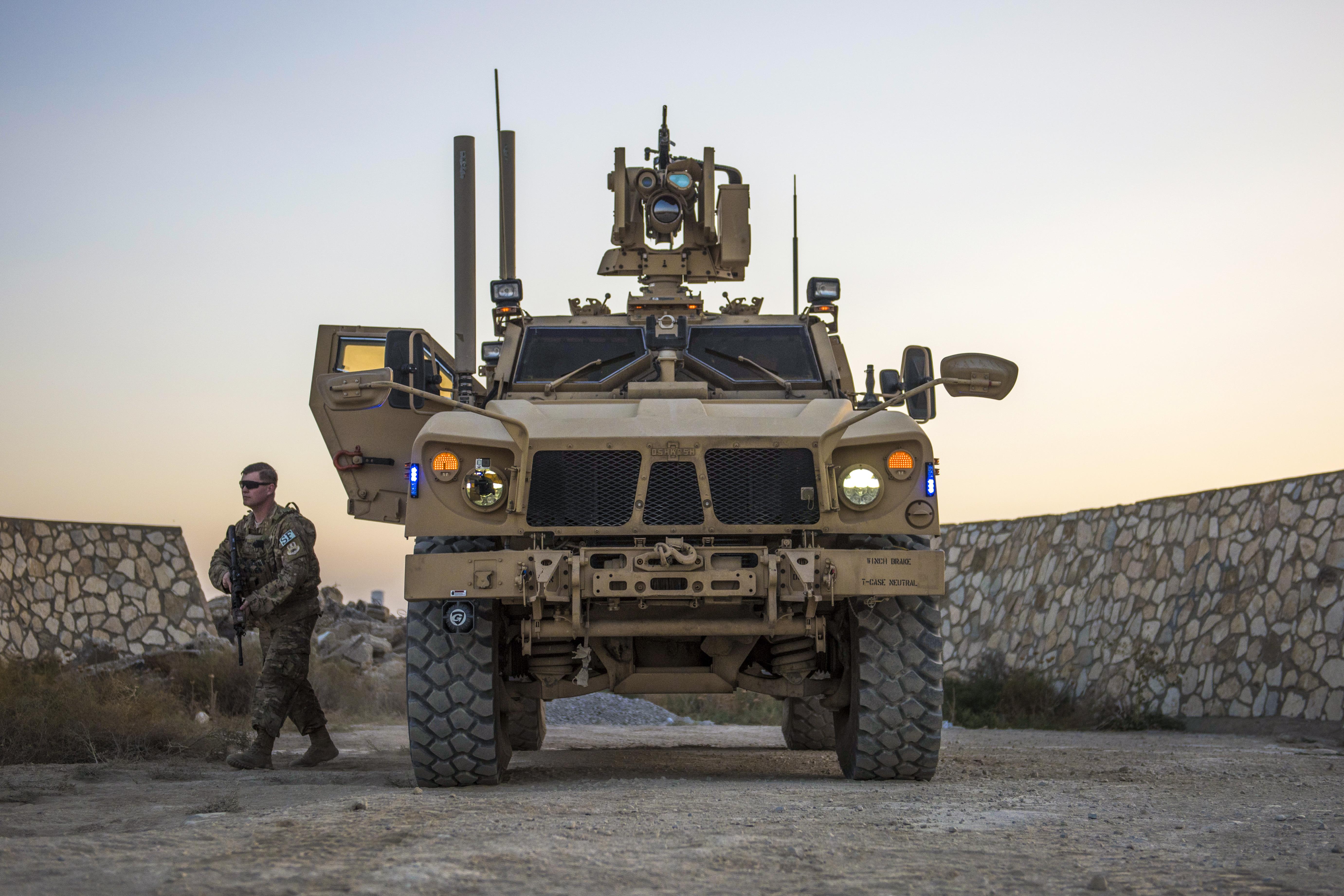 Air Force Senior Airman Michael Van Deusen gets out of a mine-resistant, ambush-protected vehicle to check buildings and a bunker during a flightline security patrol at Bagram Airfield, Afghanistan, Sept. 27, 2016. Deusen is a quick reaction force member assigned to the 455th Expeditionary Security Forces Squadron. Air Force photo by Senior Airman Justyn M. Freeman