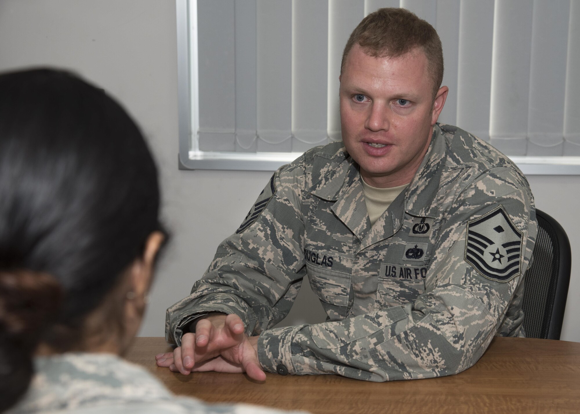 U.S. Air Force Master Sgt. Ryan Douglas, first sergeant, speaks with Staff Sgt. Maria Leal-Reynolds, a command support staff technician, both with the 35th Communications Squadron, about the variety of programs the first sergeants offer to unit personnel at Misawa Air Base, Japan, Sept. 26, 2016. Programs include Operation Warmheart, Safehaven and Veteran of Foreign Wars Unmet Needs, which are emergency relief funds raised by first shirts and other Misawa AB organizations. (U.S. Air Force photo by Airman 1st Class Sadie Colbert)