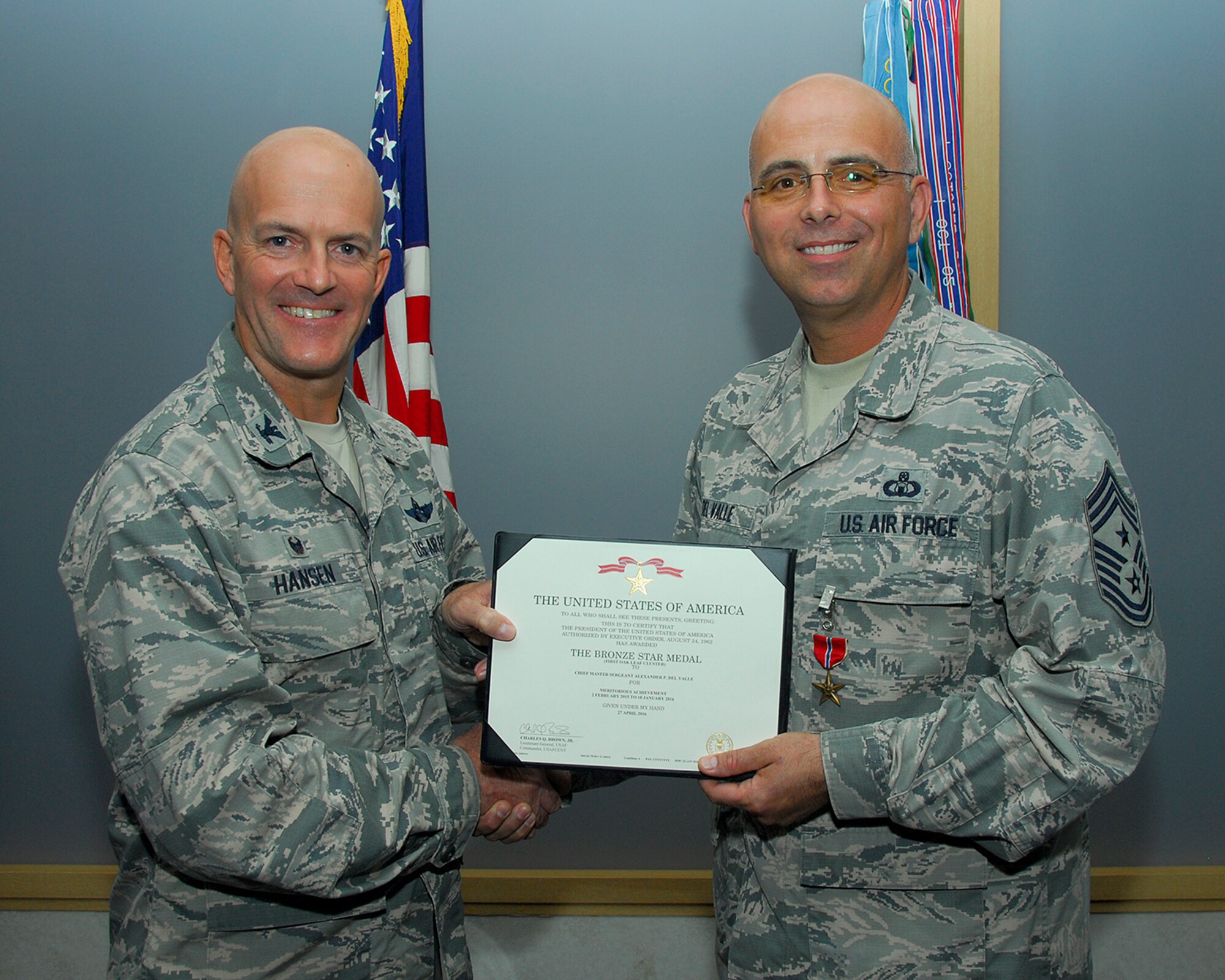 U.S. Air Force Col. Andrew Hansen, 51st Fighter Wing commander, and Chief Master Sgt. Alexander Del Valle, 51st FW command chief, pose for a photo after Del Valle received a Bronze Star Medal Sept. 27, 2016, at Osan Air Base, Republic of Korea. Del Valle received the BSM for his accomplishments serving as the 438th Air Expeditionary Wing command chief at Forward Operating Base Oqab, Kabul, Afghanistan, from February 2015 to January 2016. (U.S. Air Force photo by Kyong Hwan Song)